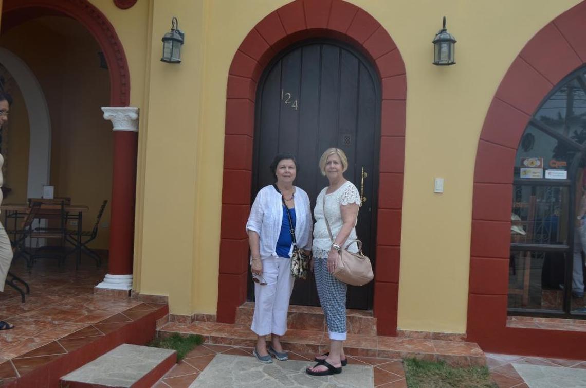 My mother, Isolina (left), and aunt Mercedes stand in front of the home they lived in as children in the Miramar section of Havana. The home is now a Spanish restaurant.