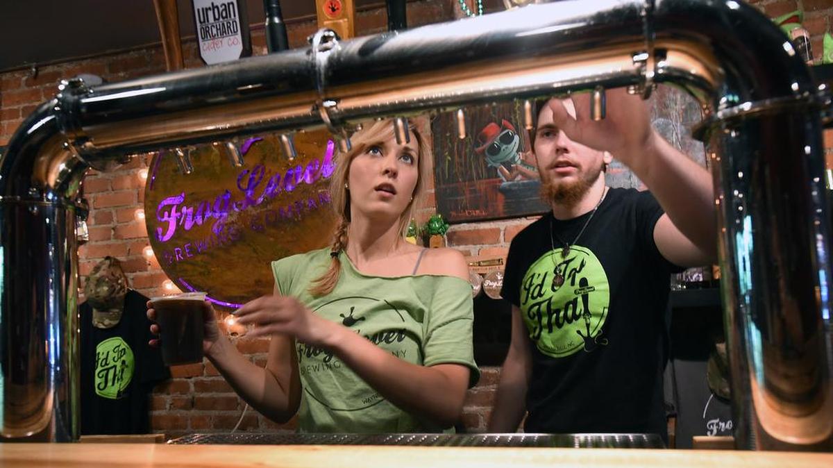 
Kristen Delliveniri and Joshua Mathews check the taps at the Frog Level Brewing Company in Waynesville, N.C. Wednesday, August 5, 2015. Waynesville is referred to by locals as the entrance to the Smoky Mountains.

