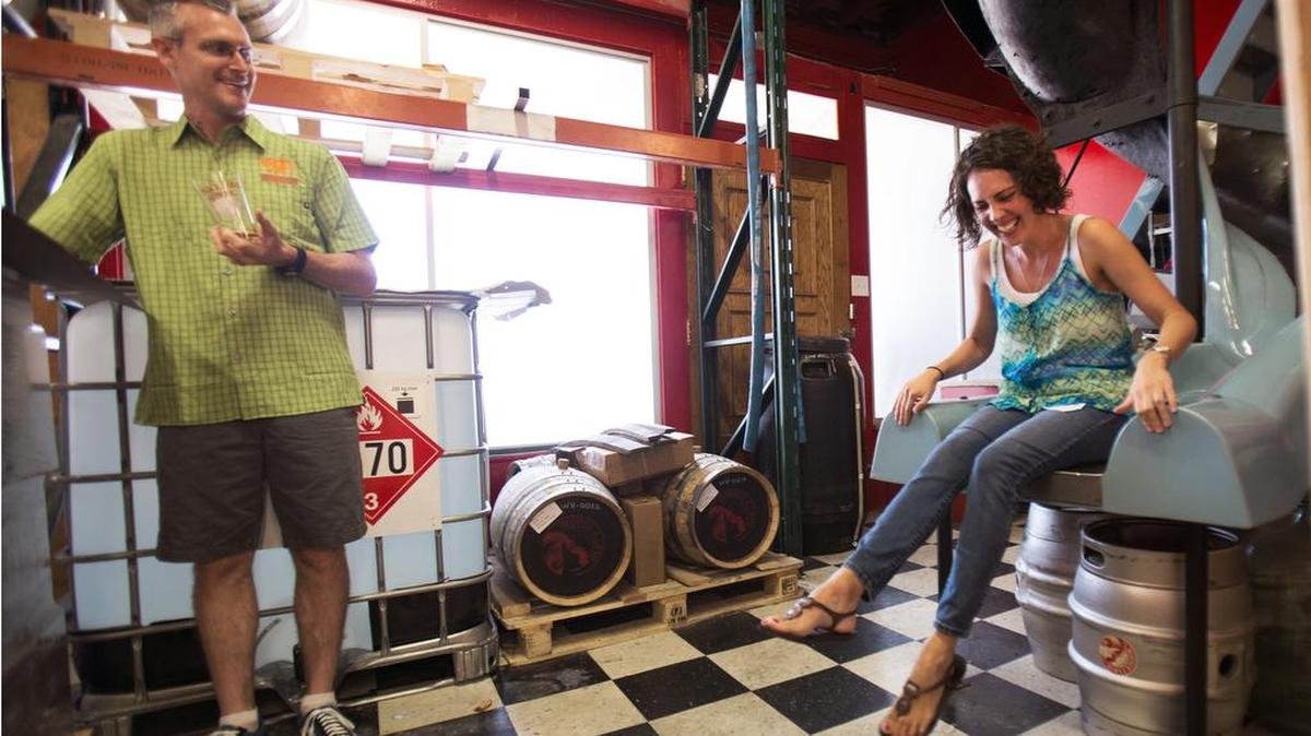 
For a special treat on her birthday, Katie Motola slides down the employee slide at Mother Earth Brewing in Kinston during a tour of the facility with the Greenville Chapter of Girls Pint Out on Friday, July 24, 2015, as tour guide Josh Brewer enjoys the moment.
