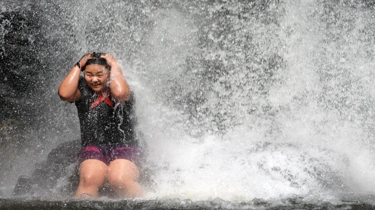 
T.K. Lee, of Augusta, Ga. enjoys the chilling waters of Looking Glass Falls in the Pisgah National Forest August 4. She was visiting the area with a church group and they stopped to beat the heat on the hot summer day.
