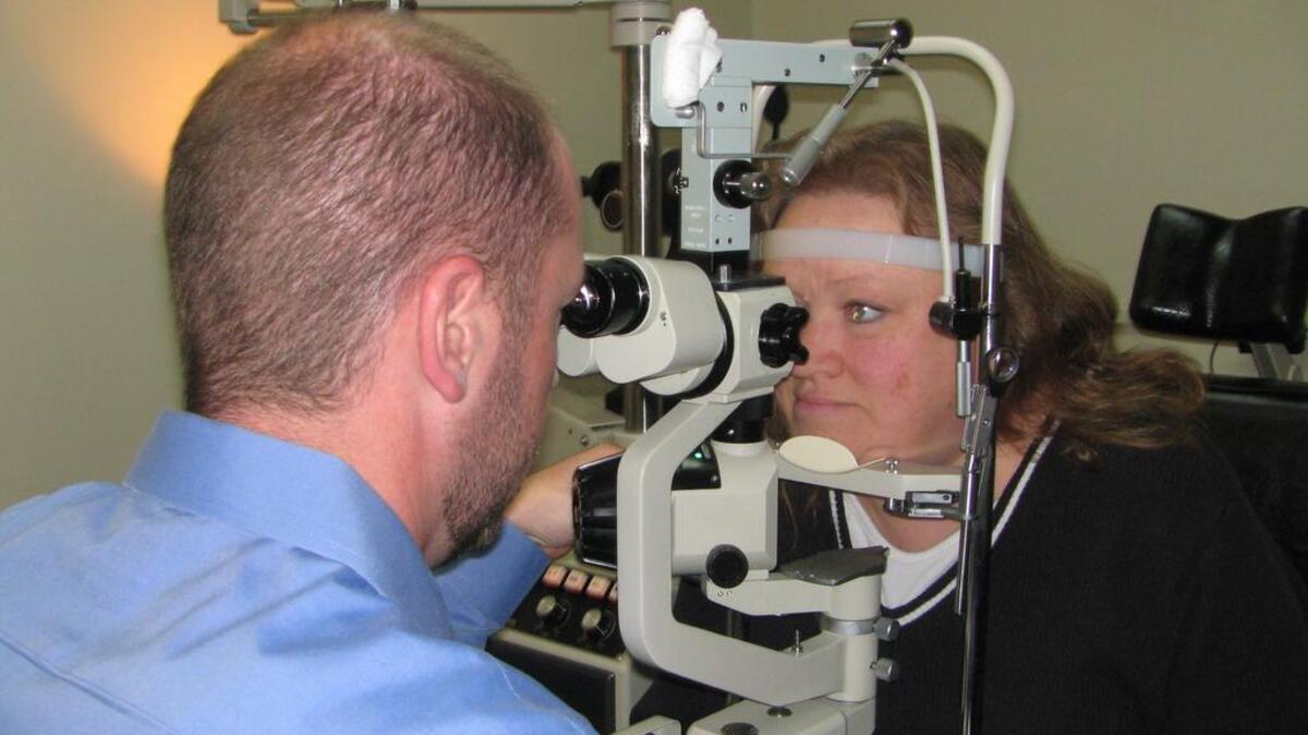 Dr. Chuck Monson of the Eye Care Center Road in Mooresville administers an eye exam recently to Laura Stevenson, 50, of Mooresville.