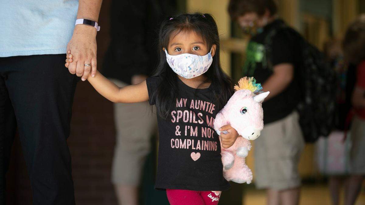 Angelique Perez, a pre-kindergartener at Pine Level Elementary School, waits for her mother in the car pool line at the end of the school day on Tuesday, October 13, 2020 in Pine Level, N.C.