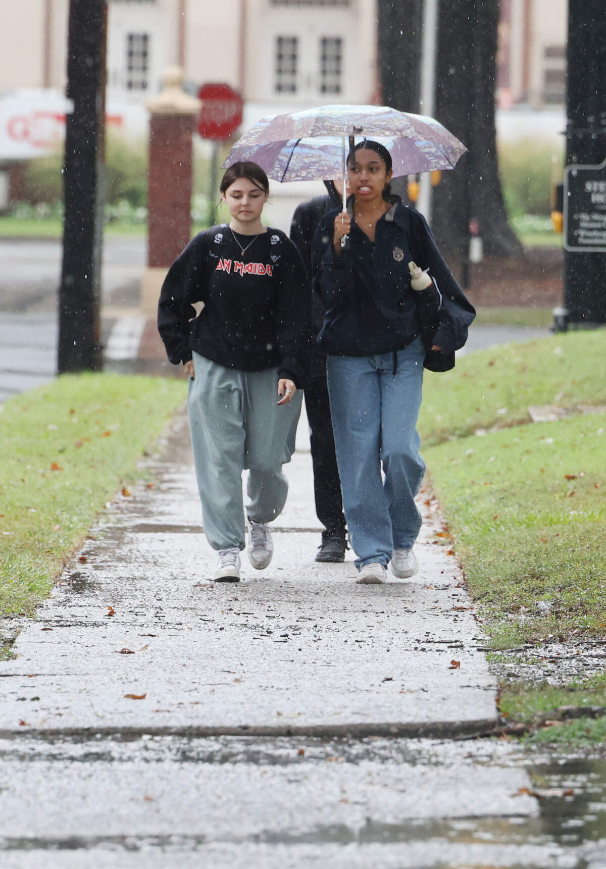 Haley Kivett, left, and Lauren Johnson walk in the rain at Winthrop University Thursday.