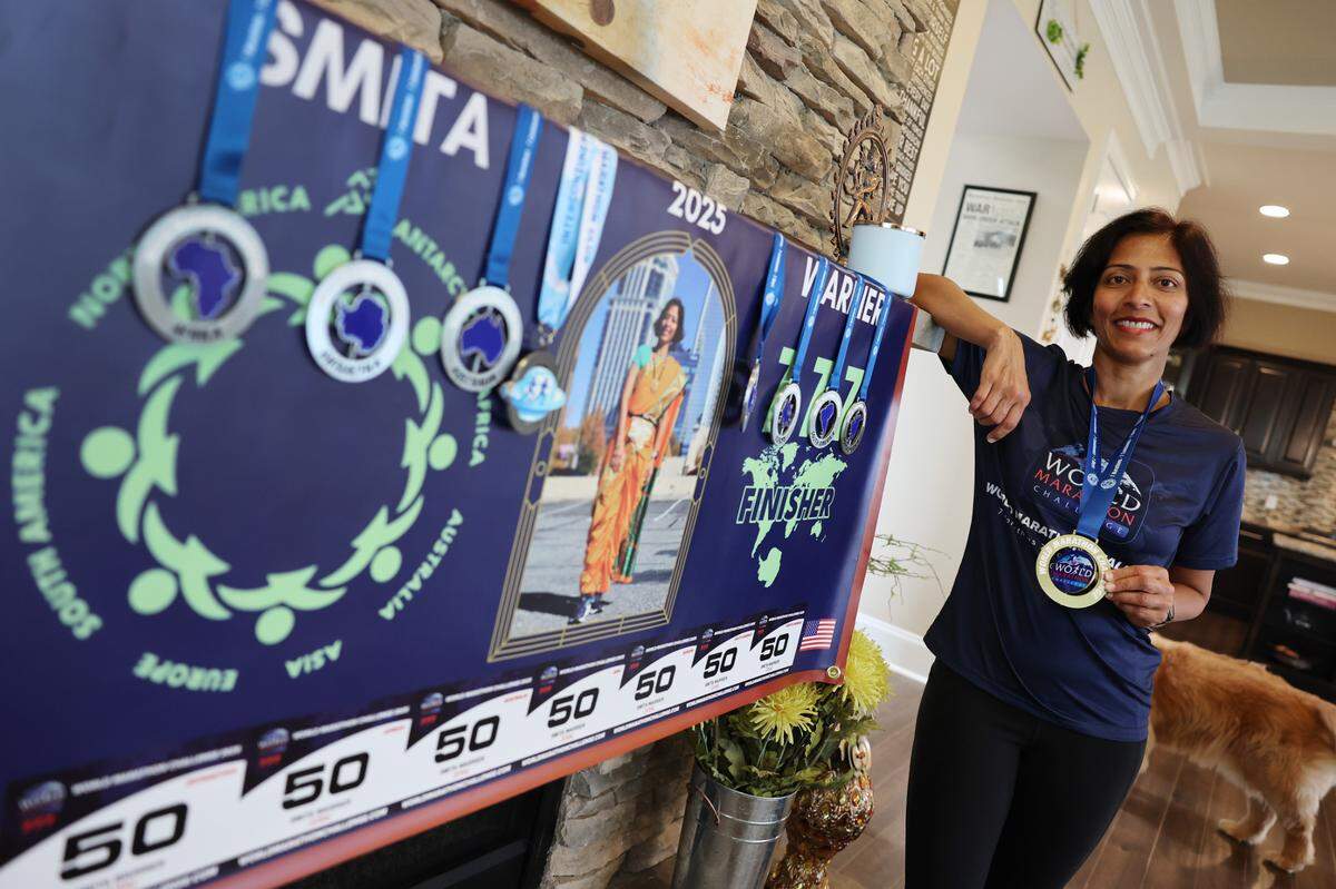 Smita Warrier of Waxhaw shows off the medals she received after running her seven straight marathons.
