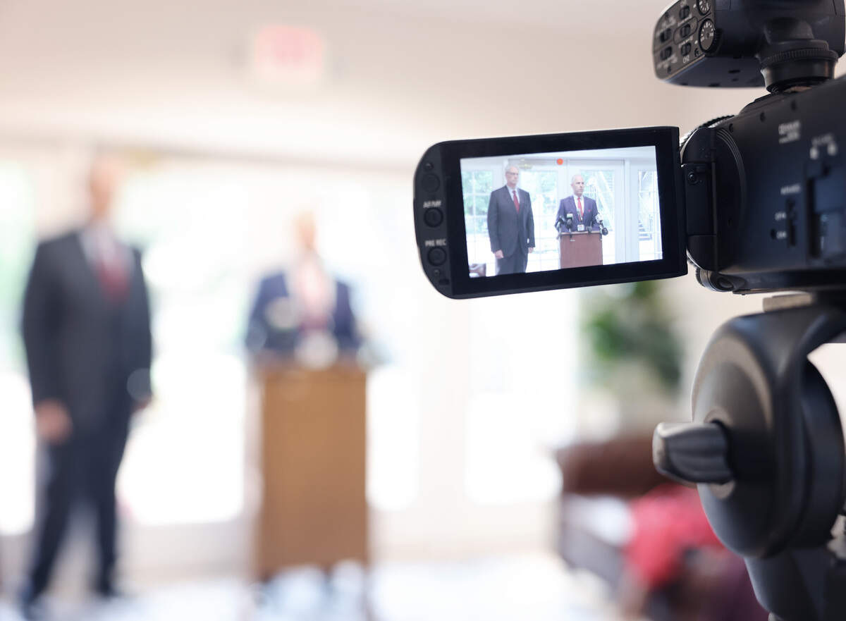 Randy Hood, right, and Chad McGown speak to reporters Monday about a lawsuit involving Erickson Lee. A judge sentenced Lee nine years in prison on Sept. 6 after Lee pleaded guilty in An Alford plea to sex crimes involving minor boys.