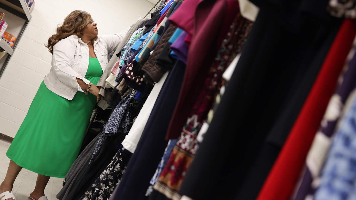 Nikita Baxter, director of student life at York Technical College in Rock Hill, sorts through clothing at the school’s Career Closet.