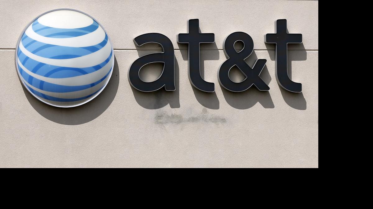 
An AT&T logo on a store in Dedham, Mass. AT&T Mobility LLC has been hit with a $100 million fine for offering consumers “unlimited” data, but then slowing their Internet speeds after they hit a certain amount. The Federal Communications Commission, which regulates the telecommunications industry, says the company misled consumers with the plans.
