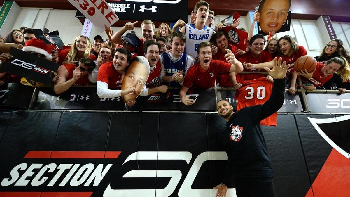 NBA star and former Davidson Wildcats Steph Curry poses with students in front of the newly renamed Section 30 for Curry’s uniform number he wore during his Davidson career on Jan. 24, 2017.