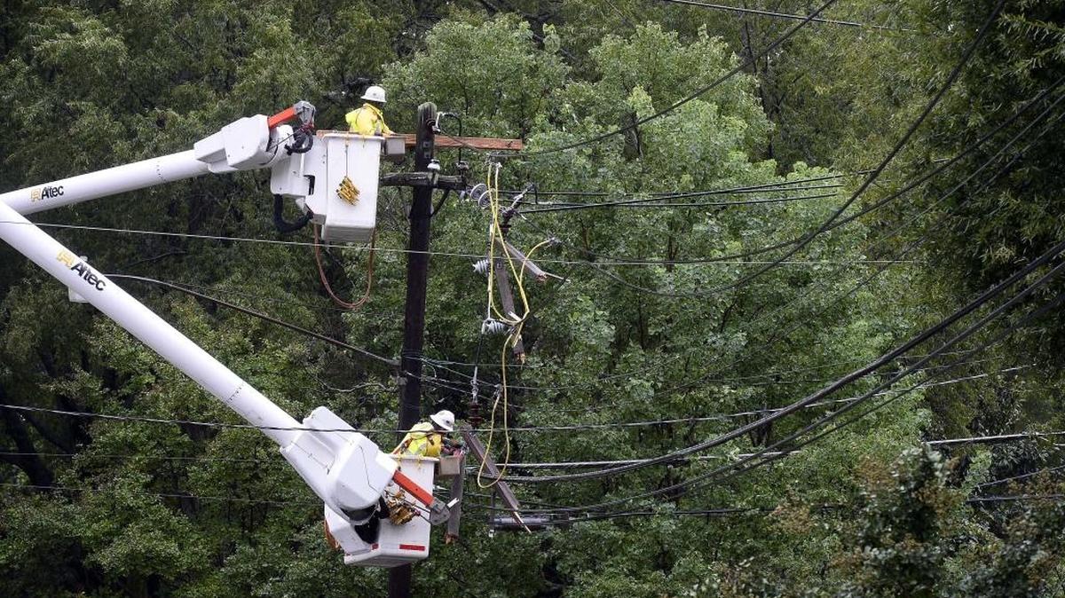 Duke Energy workers on the scene working to restore power after a large tree fell on power lines at the1300 block of Euclid Ave. in Dilworth on Oct. 3,2015.