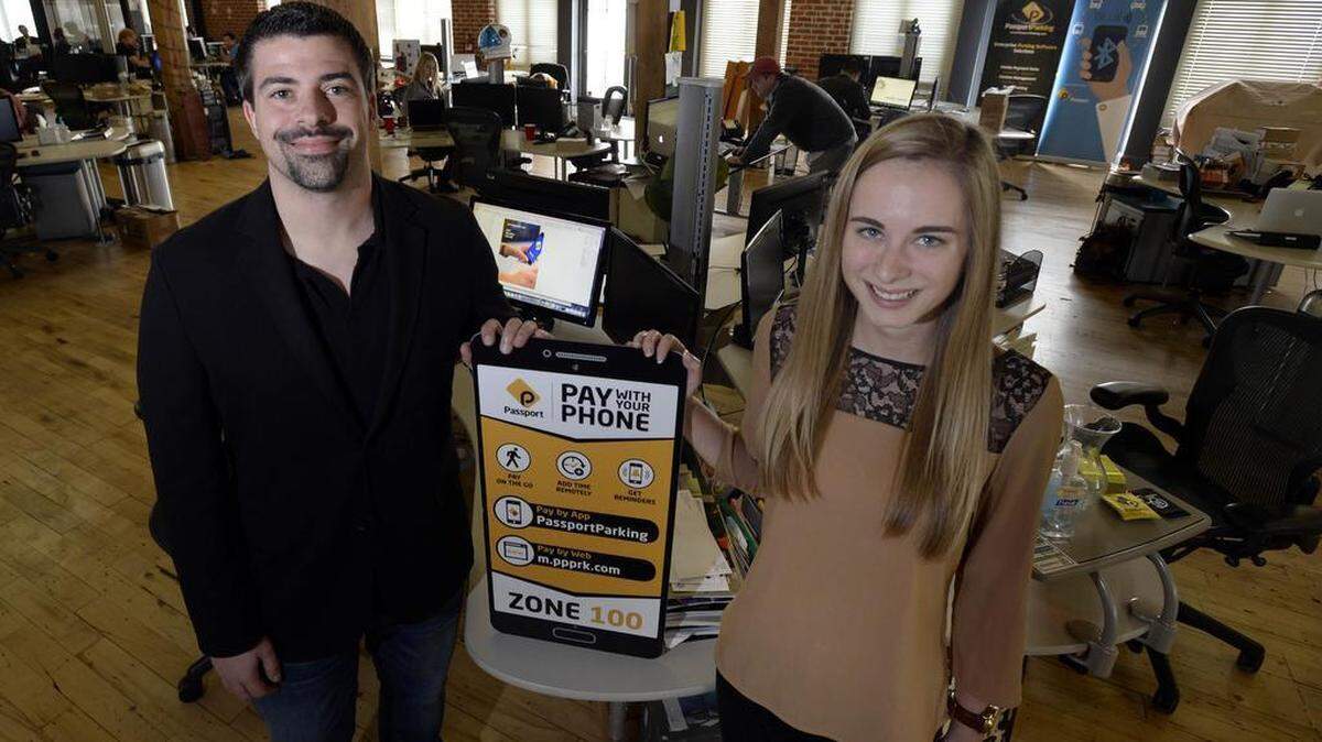 Daniel Bliley, left, director of marketing, and Emily Wilson, marketing specialist, at the offices of Passport on Thursday, October 29, 2015. The Charlotte company specializes in developing software to manage mobile payments for parking and transit in cities. They are one of the few companies in Charlotte that has received venture capital funding.