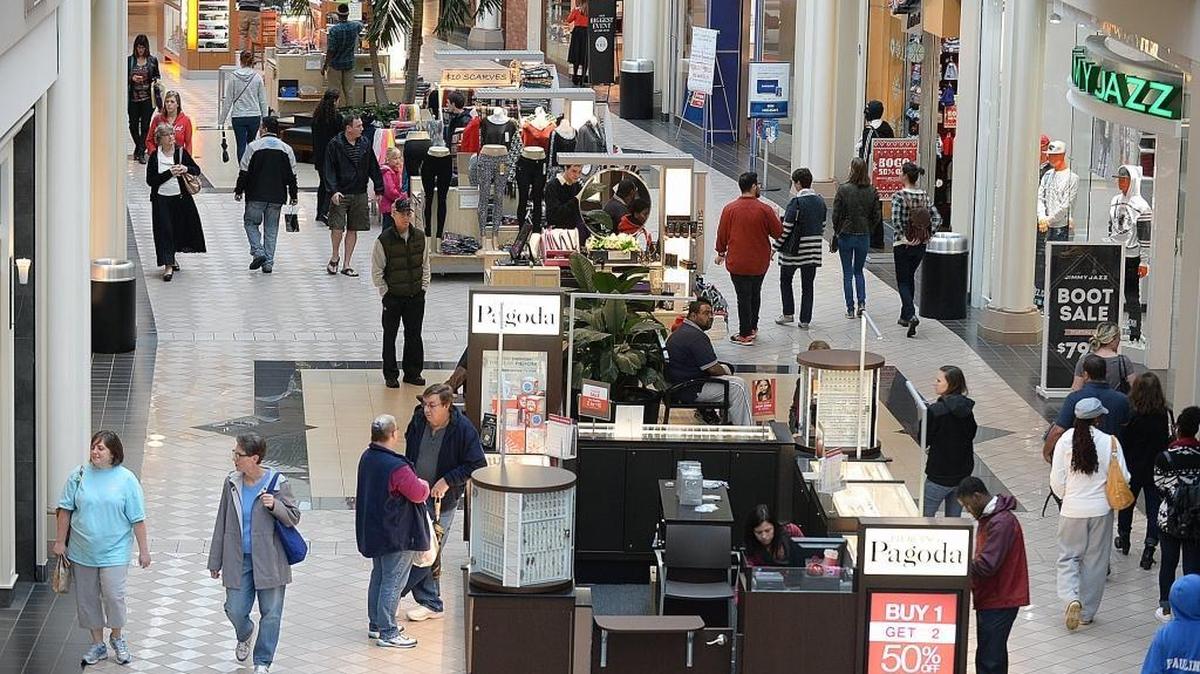 Retailers display their sales signs in the window as holiday shoppers crowd Carolina Place Mall to find last minute sale deals in this December 2015 photo.