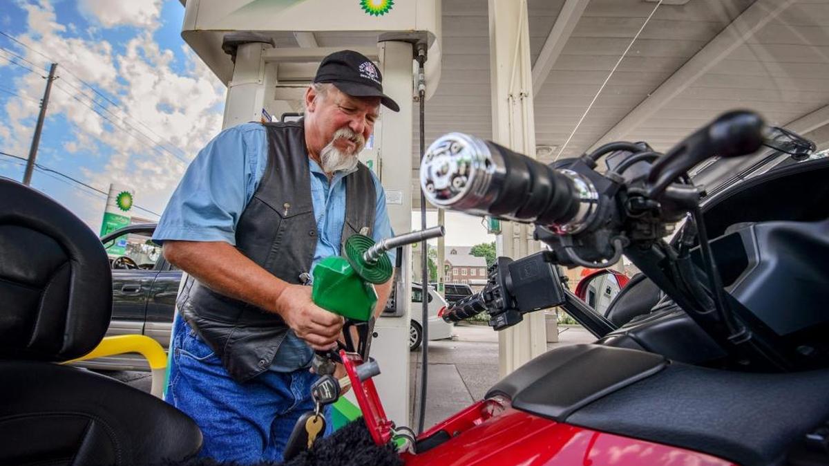 
Bob Lodin fills his motorcycle at a BP gas station in South Minneapolis, Minn., in early September. Gas prices edged up over the last week as oil refineries undergo maintenance, according to auto group AAA. 
