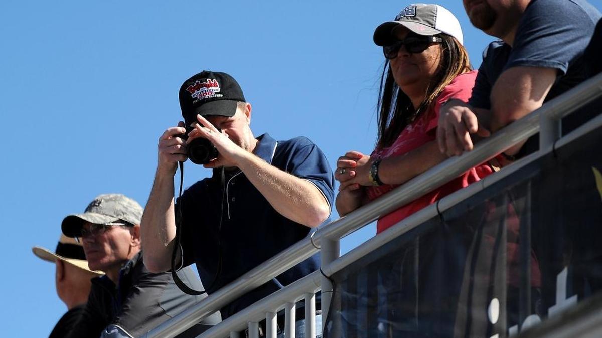 NASCAR Sprint Cup Series fans line a railing in the Fan Zone during practice at Daytona International Speedway in February.