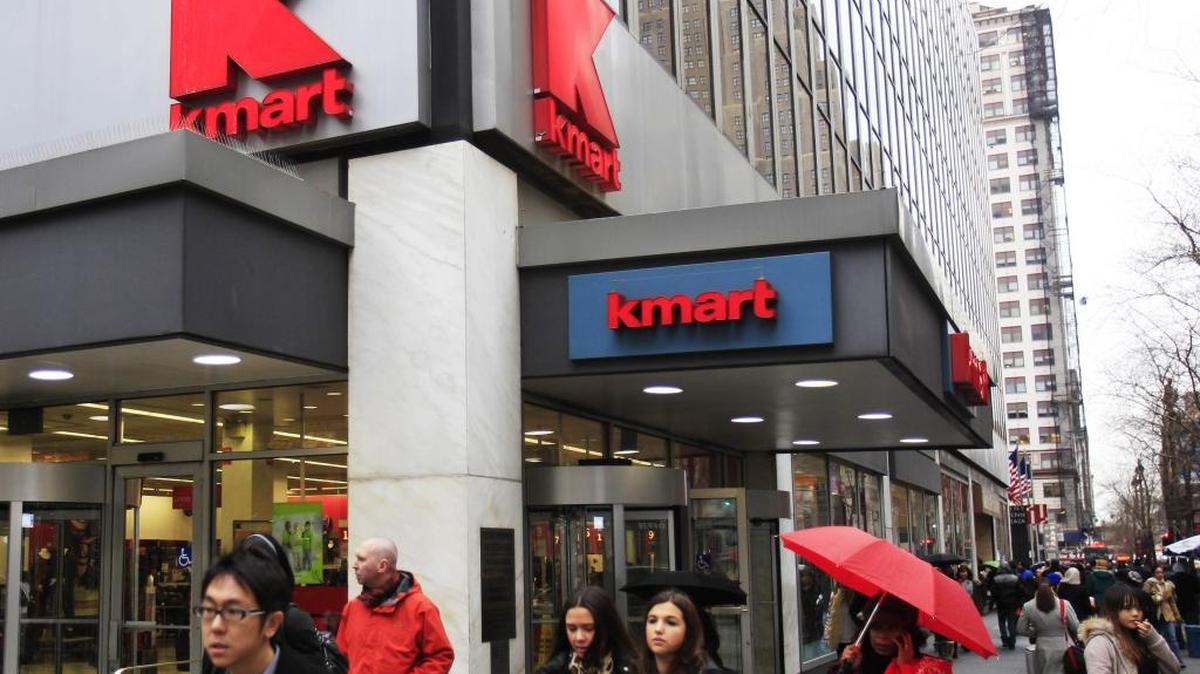 In this Dec. 27, 2011, file photo, pedestrians pass a Kmart location in New York. Sears Holdings Corp. is announcing Thursday, April 21, 2016, that it will close 68 Kmart stores and 10 Sears stores as it struggles to restore profitability.