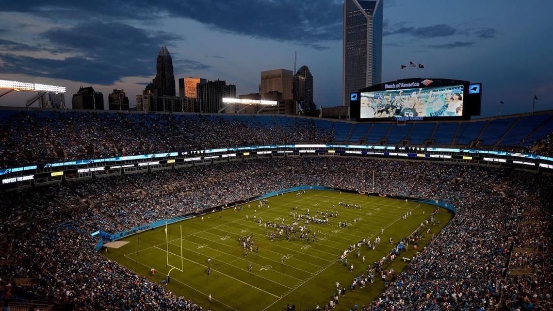 The Charlotte skyline serves as a backdrop for fans gathered at the Carolina Panthers Fan Fest at Bank of America Stadium on August 7, 2015.