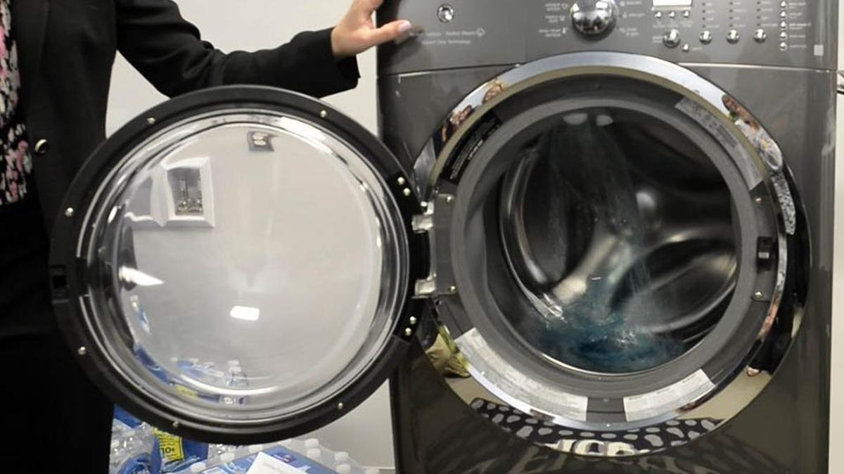 Nina Harrison shows off the wash cycle of a new washing machine during a tour of appliance-maker Electrolux's new fabric care research and development facility in Charlotte on March 26, 2014.