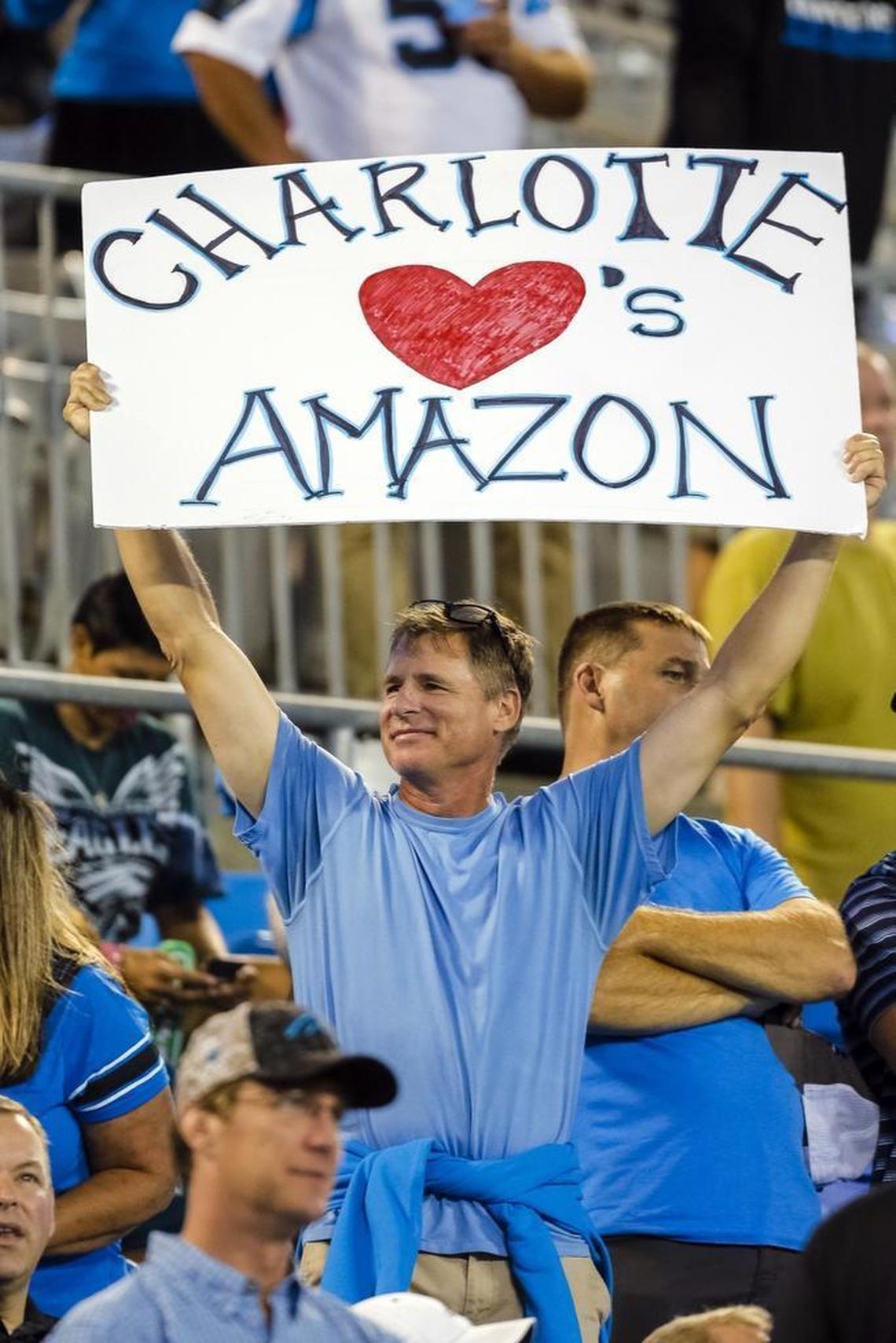 In this Oct. 12, 2017, file photo, a Carolina Panthers fan shows his desire for Amazon to make Charlotte its East Coast headquarters before an NFL football game against the Philadelphia Eagles in Charlotte.