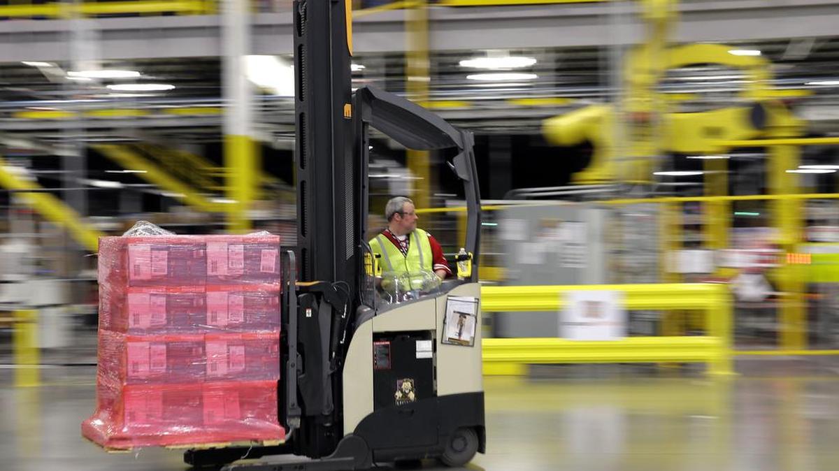 A forklift operator moves a pallet of goods at an Amazon fulfillment center in DuPont, Wash. Amazon said Tuesday it will add 100,000 holiday jobs this season across the country in its fulfillment and sortation centers, so that it can meet increased customer demand.