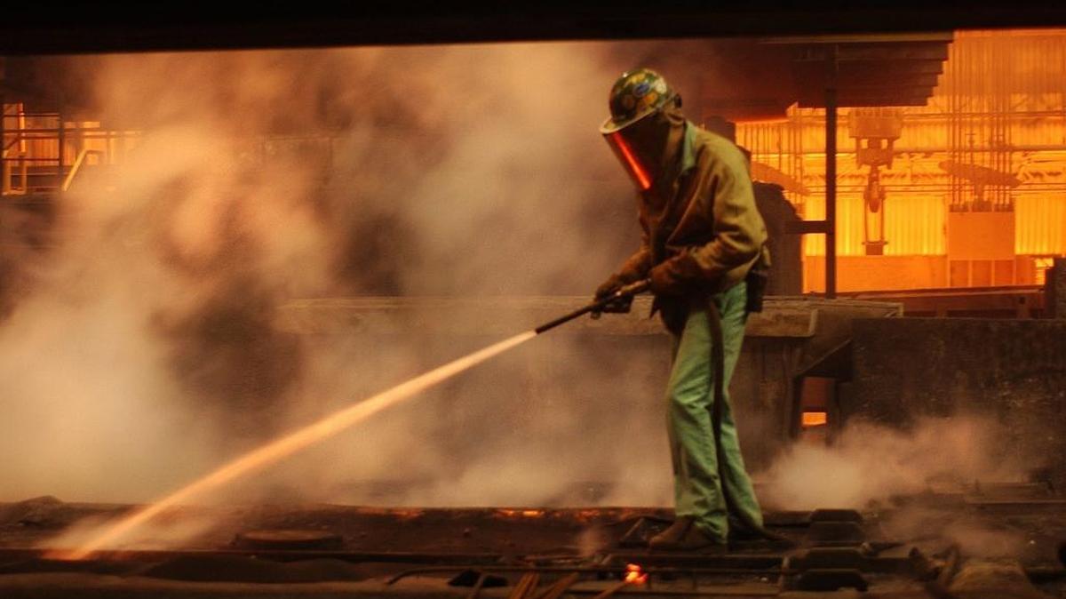 In this file photo, a Nucor employee sprays water on molten steel which solidifies the end capping off a strand where steel plates are cast. The Charlotte-based company disclosed Friday that CEO John Ferriola made $8.9 million in 2015.