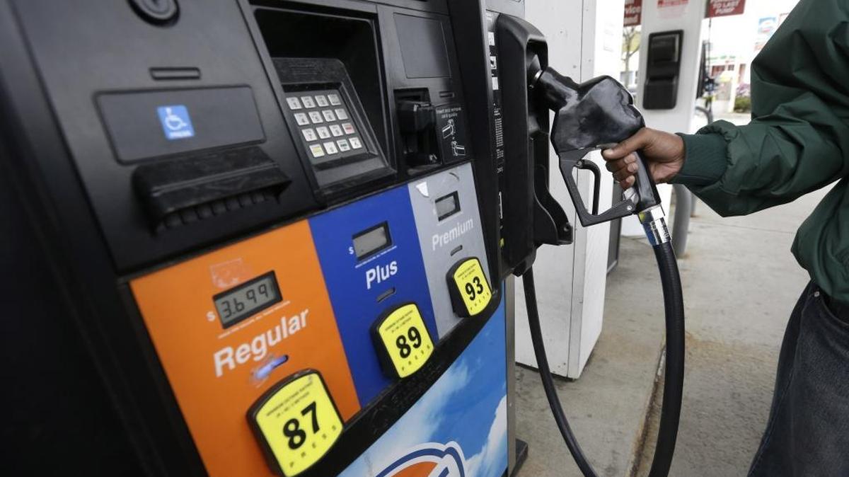
In this April 29, 2014 file photo, Yosef Wolday fills his car with fuel at a gasoline station, in Brookline, Mass.
