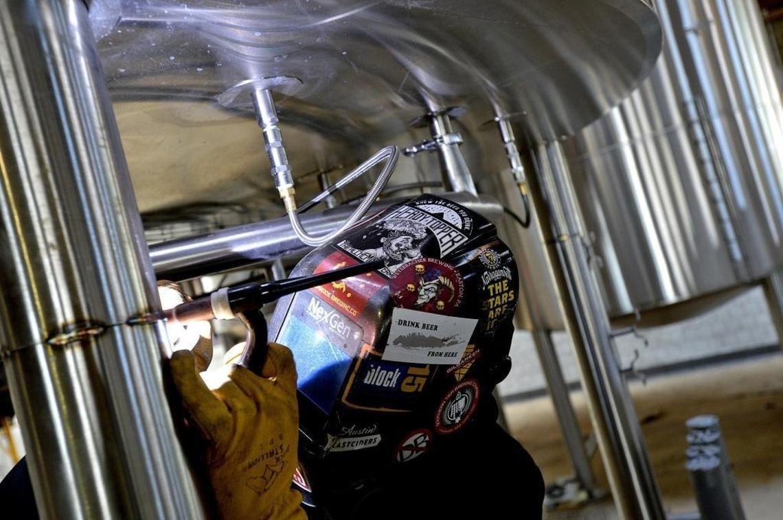 Stephen Lyons welds a leg onto at later tun inside the new Southern Tier and Victory brewery in South End.