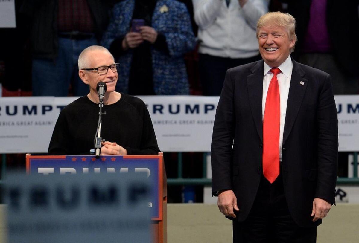 Former NASCAR Sprint Cup Series driver Mark Martin, left, speaks during a rally for GOP presidential candidate Donald Trump, right, at the Cabarrus Arena in March 2016.