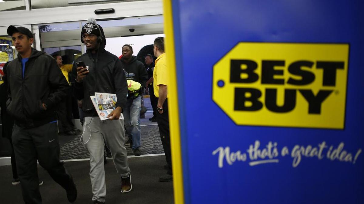 Best Buy is among the U.S. retailers offering free shipping. In this photo, shoppers enter a Best Buy store in Chesapeake, Va.