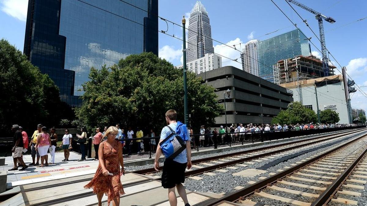People line up along the Lynx Blue Line waiting to enter the Charlotte Convention Center in July.