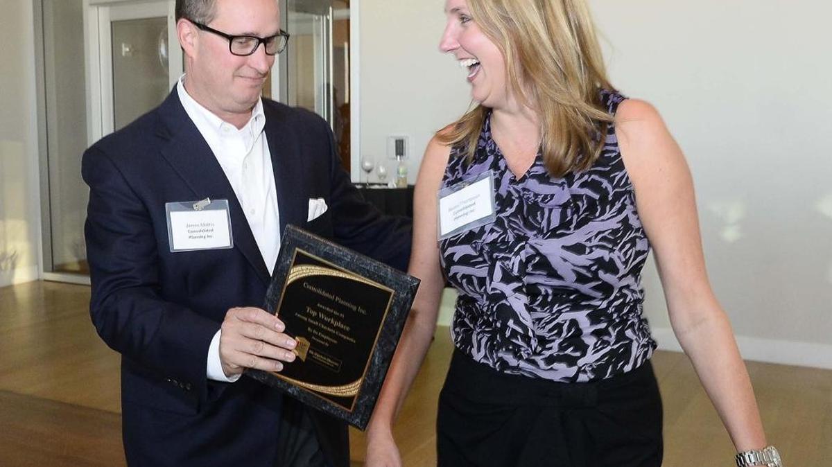 From left, James Mathis, Becky Thompson with Consolidated Planning Inc. show their excitement after receiving a first-place award in the small company category during the Top Workplaces reveal event last September. Consolidated Planning, a financial planning firm, also was named a special awards winner for company ethics.