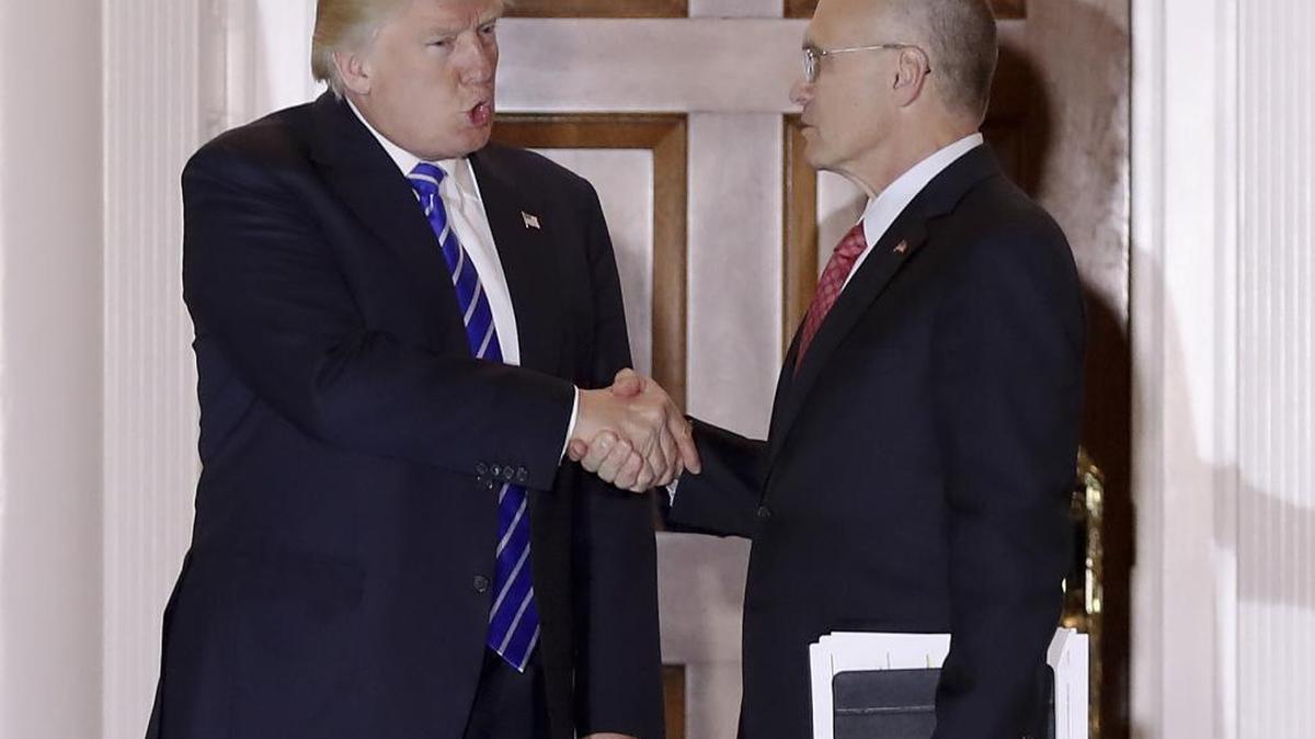 In this Saturday, Nov. 19, 2016, file photo, President-elect Donald Trump and Andy Puzder, chief executive of CKE Restaurants, shake hands as Puzder leaves Trump National Golf Club Bedminster clubhouse in Bedminster, N.J. Trump has tapped Puzder as his pick to head the Labor Department.