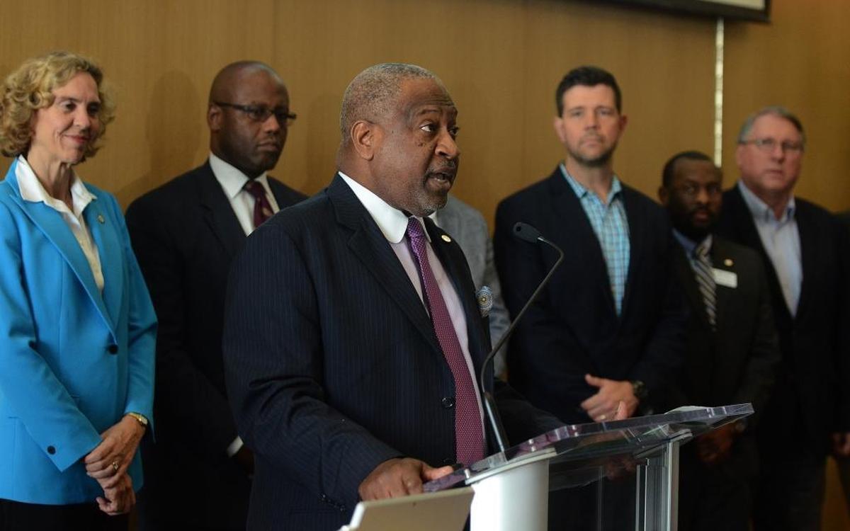 Ronnie Bryant, President and CEO of the Charlotte Regional Partnership, center, speaks at Wednesday’s Amazon HQ2 Media Event at the UNC Charlotte Center City building.