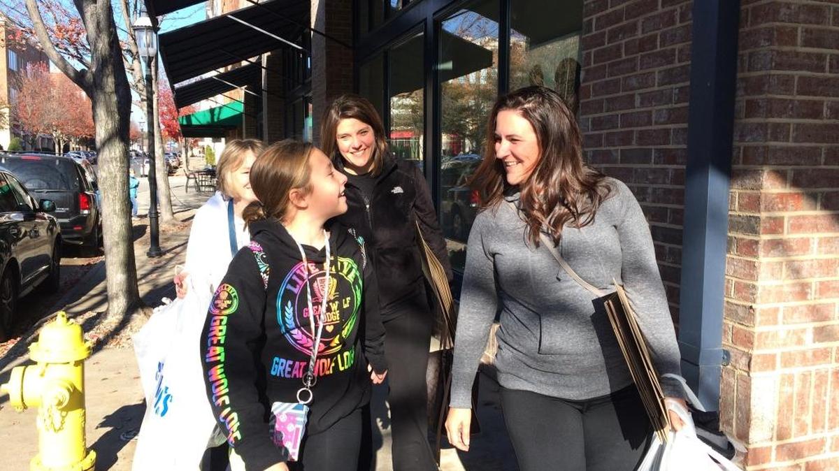 From left: Joy Baxter (background) Taylor Baxter, Anna Baxter and Krisha Baxter shop for Black Friday deals in Huntersville’s Birkdale Village shopping center.