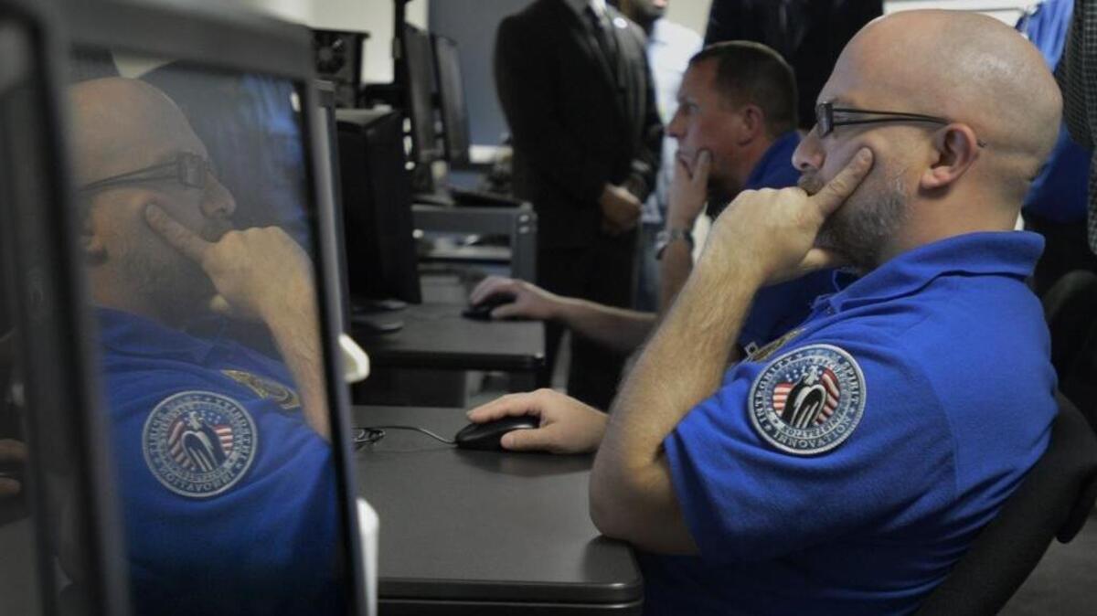 TSA agents are shown checking baggage in this 2016 file photo.