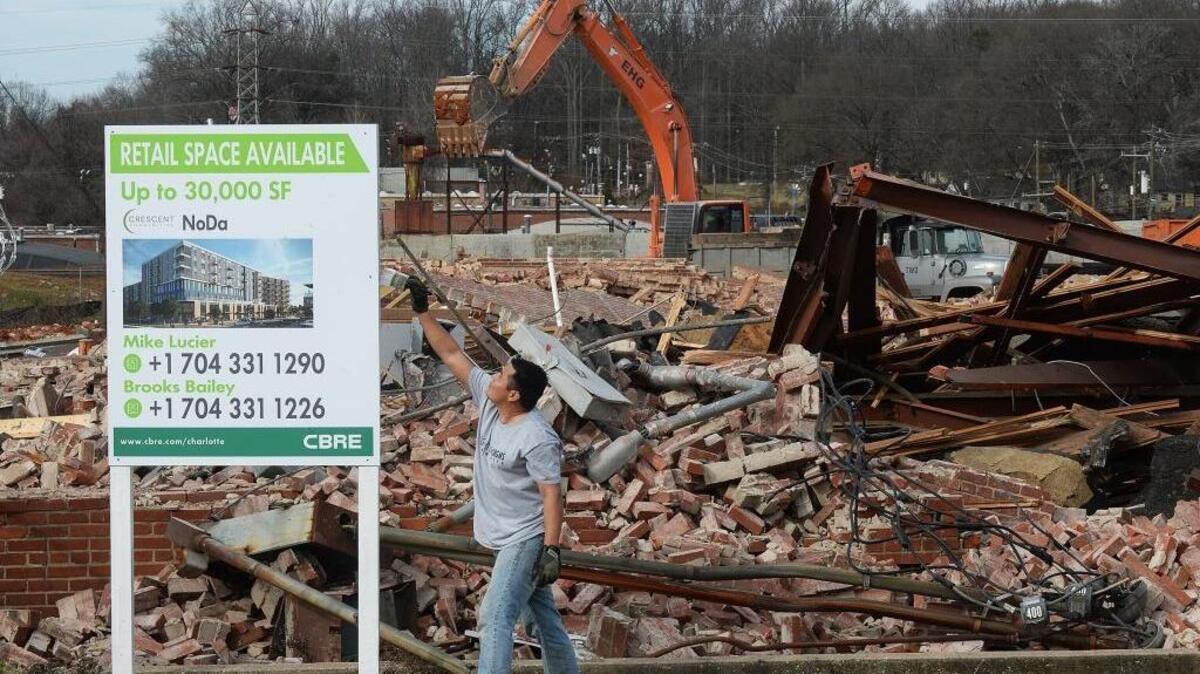 A worker puts up a sign in advance of Crescent Communities’ groundbreaking for a new apartment building in NoDa, on Jan. 27, 2016. Charlotte City Council is struggling with a rewrite of the complex rules that govern zoning, land use and what gets built where.