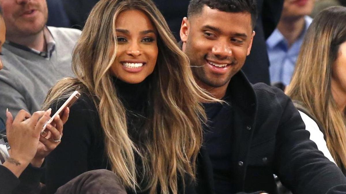 In this Feb. 9, 2016 file photo, singer Ciara, second from left, and Seattle Seahawks quarterback Russell Wilson sit courtside while attending an NBA basketball game between the New York Knicks and the Washington Wizards in New York. The couple were married Wednesday, July 6, 2016, at Peckforton Castle in Cheshire, England. (AP Photo/Kathy Willens, File)