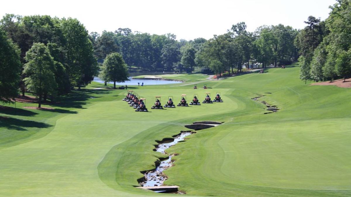 In this 2011 file photo, Jacobsen turf mowers prepare the fairway for the Wells Fargo Championship at Quail Hollow Club.