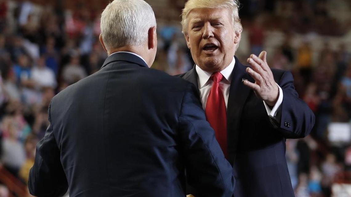 President Donald Trump is greeted by Vice President Mike Pence as he arrives to speak at the Pennsylvania Farm Show Complex and Expo Center in Harrisburg, Pa., on Saturday. Trump said in an interview that he’s actively considering a breakup of giant Wall Street banks.