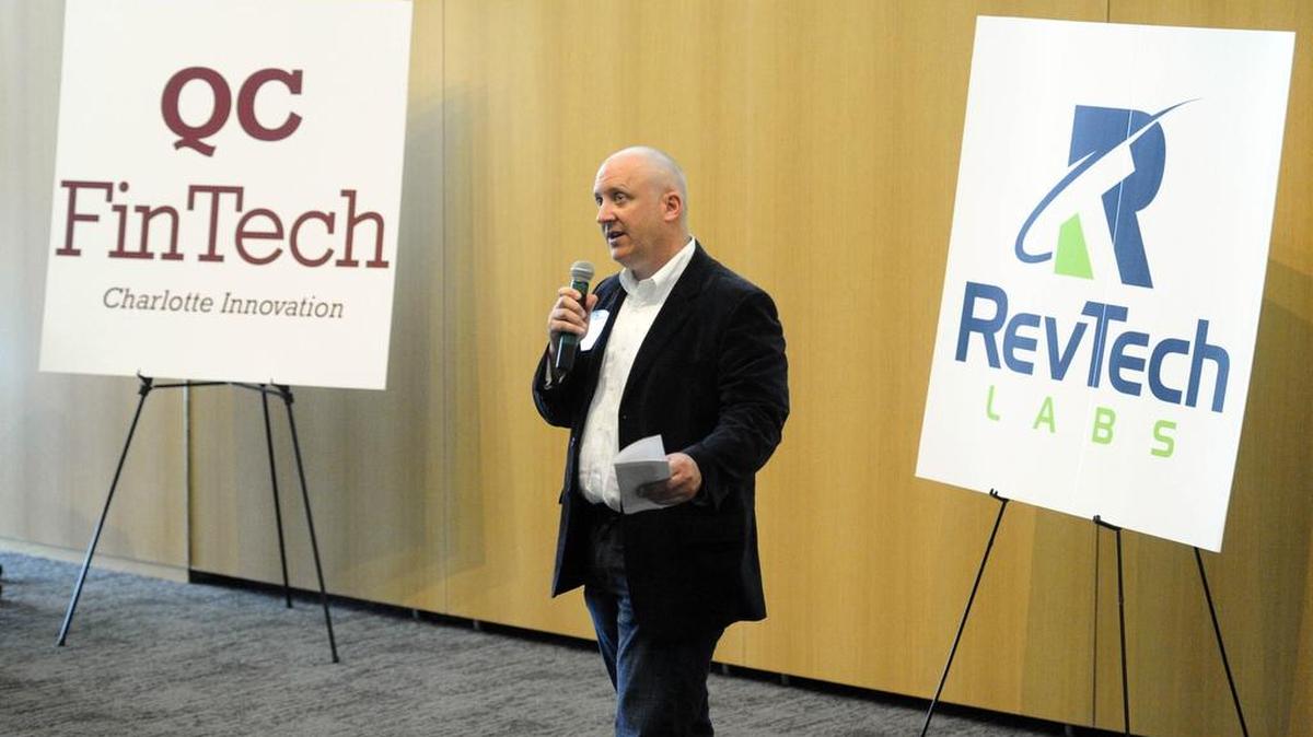
Dan Roselli, co-founder of Packard Place and RevTech Labs, talks to etch audience as he facilitates entrepreneurs presentations during Demo Day for members of the fourth class of RevTech Labs, Packard Place’s 12-week startup incubator and accelerator program. at UNC Charlotte Center City in May.
