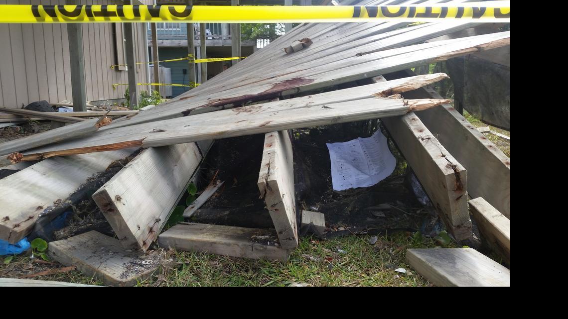 
The collapsed Emerald Isle deck sits in the grass behind the sand dunes Sunday morning. The town of Emerald Isle released its final report on the incident Tuesday.

