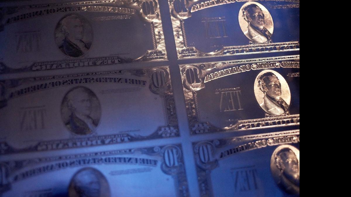 
A display of $10 note currency plates from the past century are seen at a press conference at the National Archives on June 18, 2015 in Washington, DC. U.S. Treasury Secretary Jacob Lew discussed the redesign of the $10 note to feature a woman and enter circulation in 2020, the 100th anniversary of the 19th Amendment, which gave American women the right to vote. 
