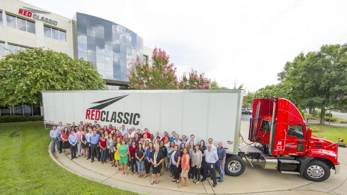 Employees gather outside their building at Red Classic, a distribution, logistics and freight company that is wholly owned by Charlotte-based Coca-Cola Consolidated.
