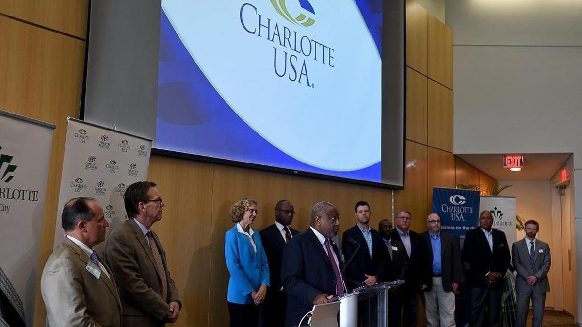 Ronnie Bryant, President and CEO of the Charlotte Regional Partnership, center, greets attendees at Wednesday's Amazon HQ2 Media Event at the UNC Charlotte Center City building.