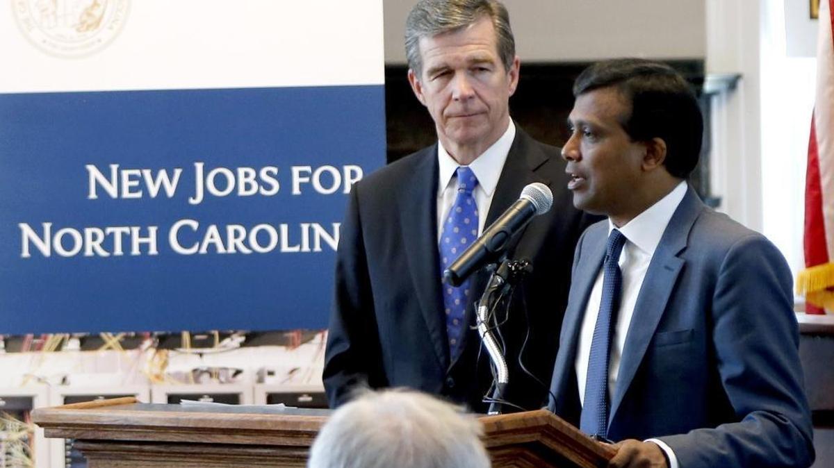 Gov. Roy Cooper, left, and Infosys President Ravi Kumar announced in July that the tech company plans to open a facility in the Triangle, where it will add 2,000 jobs. Records show that Infosys considered Charlotte for part of its expansion (500 jobs) before landing on Wake County.