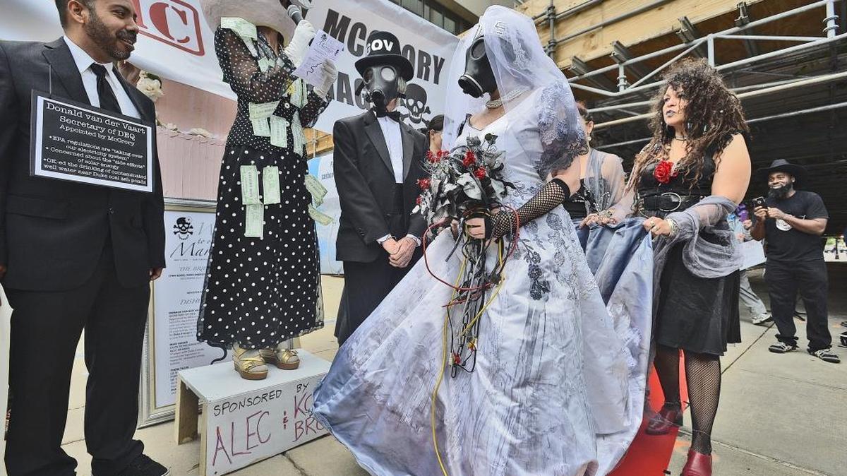 Environmental advocates protested outside Duke Energy's annual shareholder meeting in 2016 by hosting a mock marriage ceremony between Duke Energy CEO Lynn Good and then-Gov. Pat McCrory.