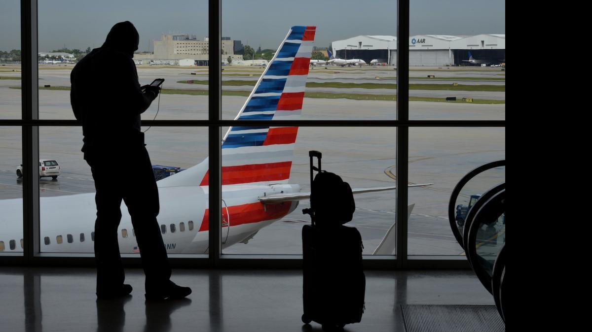 
The silhouette of a traveler is seen at the American Airlines terminal of Miami International Airport last fall. 
