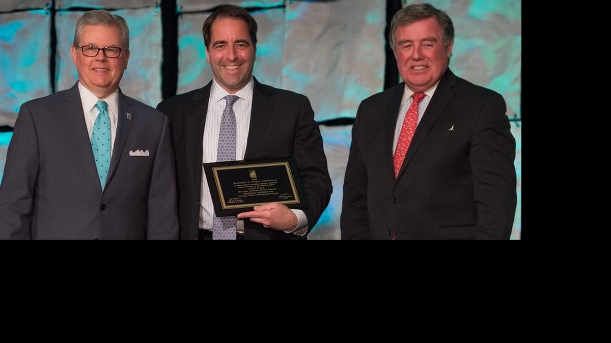 
Marko Iglendza (center) receives the Best New Consumer Service Concept Award in April for his Terminal Gateway Spa concept. Charlotte Douglas is home to one of the spas. 
