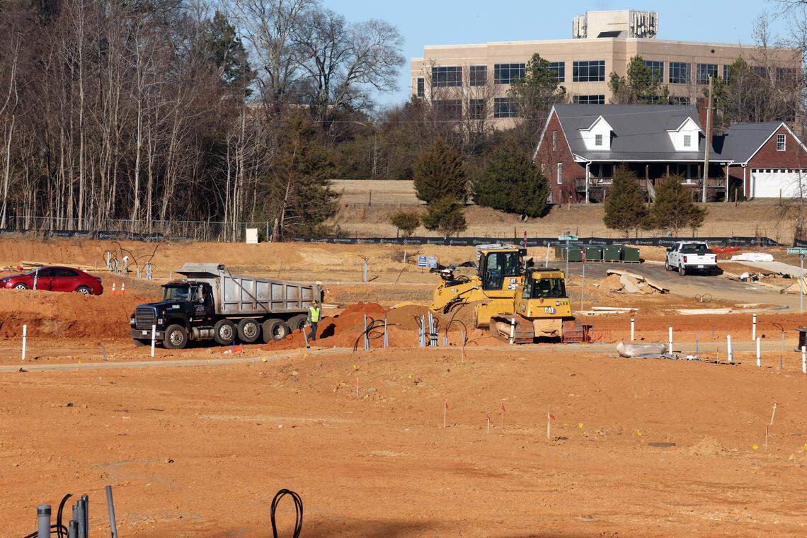 A construction crew works on a plot of land on Mallard Creek Road. It’s one of two project being built in a one-mile radius. Another proposed development would add 195 townhomes to the area. 