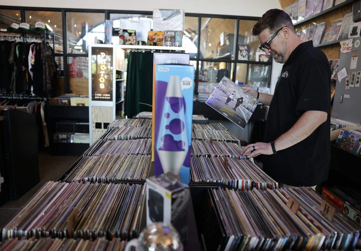 Dean Hardy, co-owner of Hardy Boys Records and Comics sorts through albums at the Camp North End location in Charlotte on Wednesday, April 15, 2026.