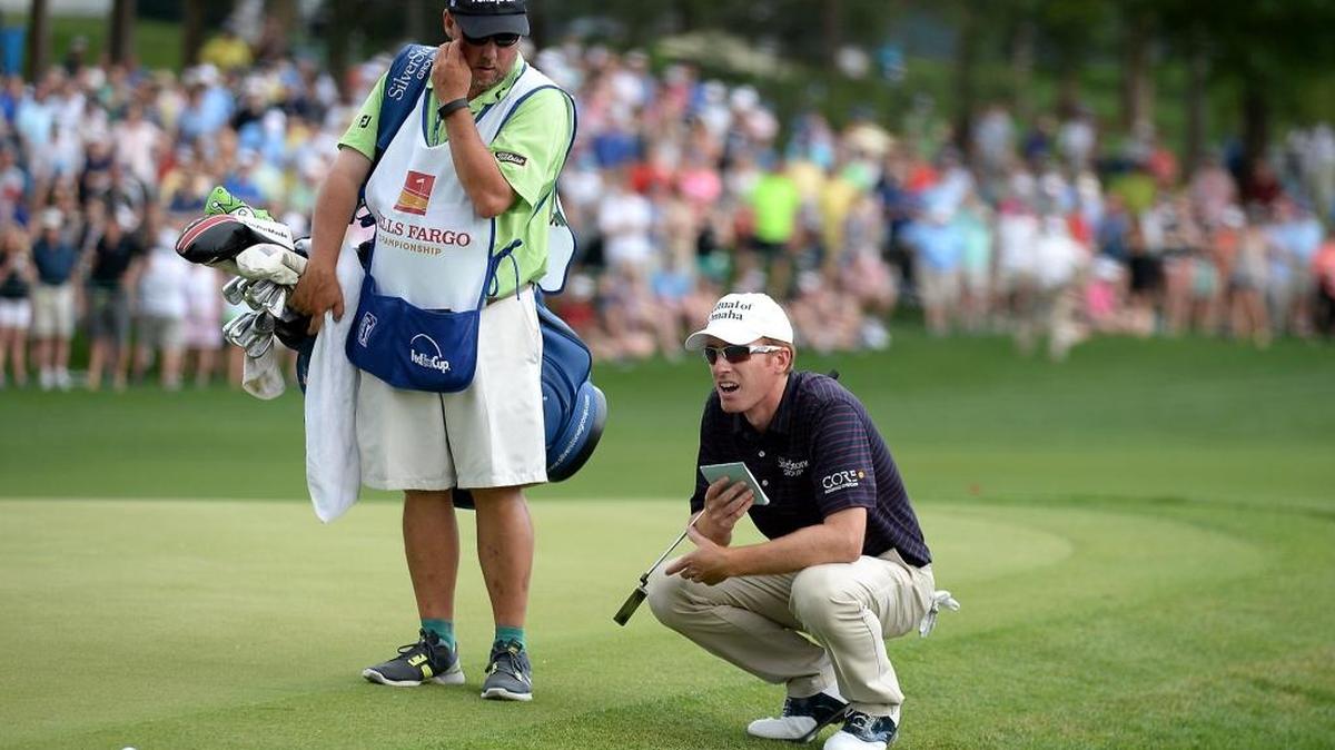 Roberto Castro, right, studies his line for a putt on the 18th green with his caddie, left, during the Wells Fargo Championship on Sunday, May 8, 2016, at Quail Hollow Club in Charlotte, NC. Castro would lose the championship to James Hahn in playoff action.
