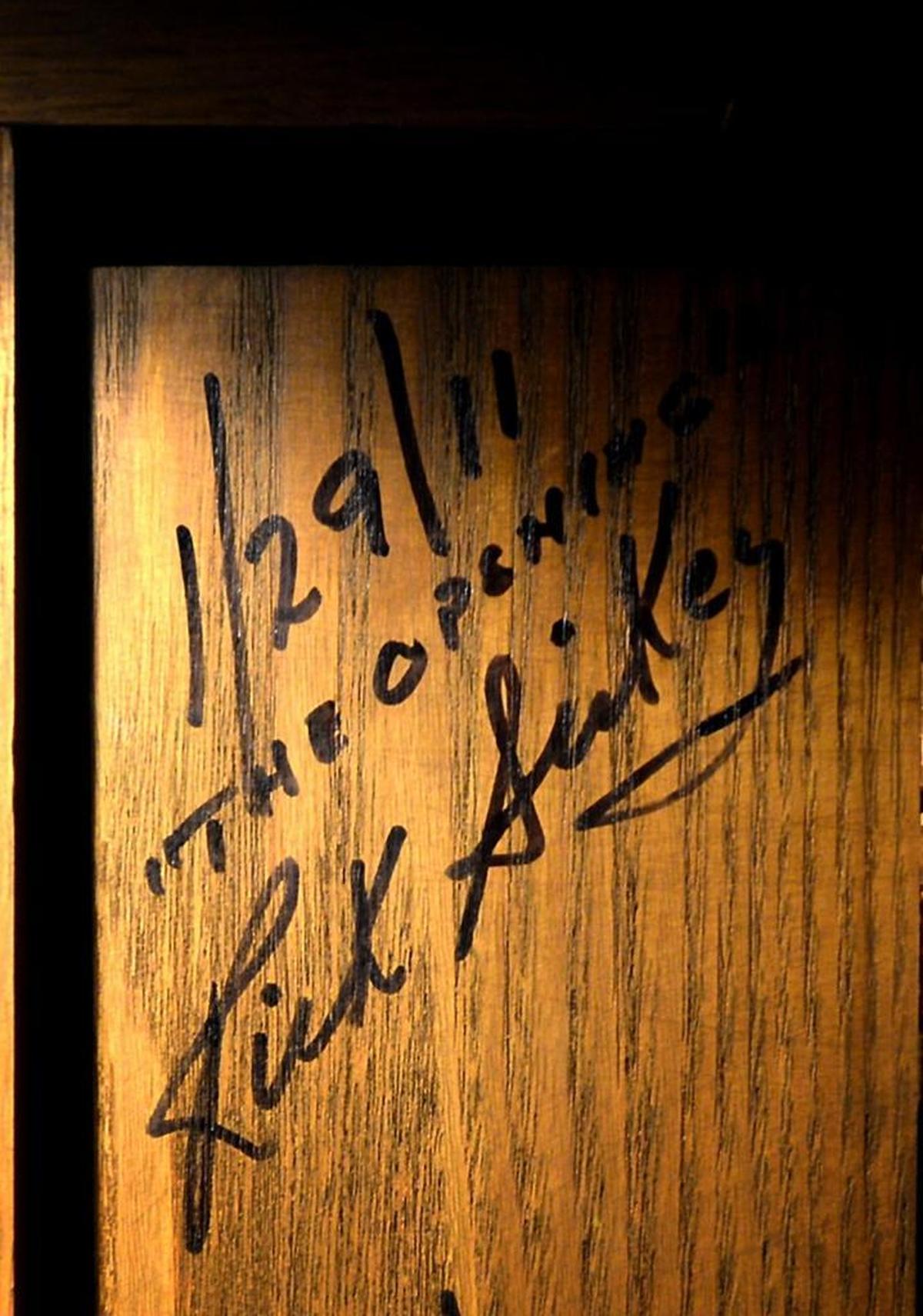 Ricky Siskey’s signature is visible near the top of a wooden door in the wine cellar/cigar room of his former home in Charlotte.